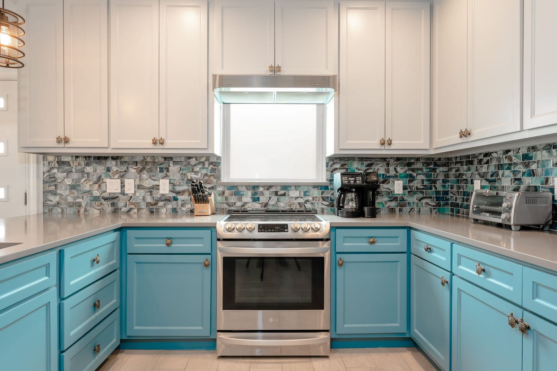 Kitchen with turquoise cabinets and gas range