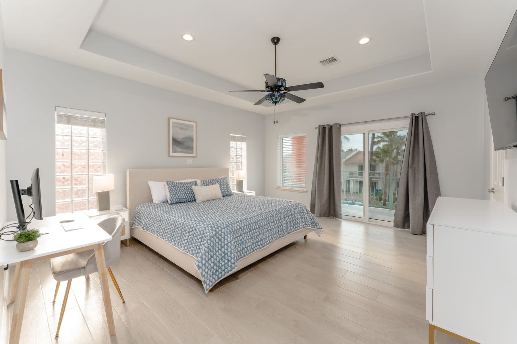 Primary bedroom with king bed and desk