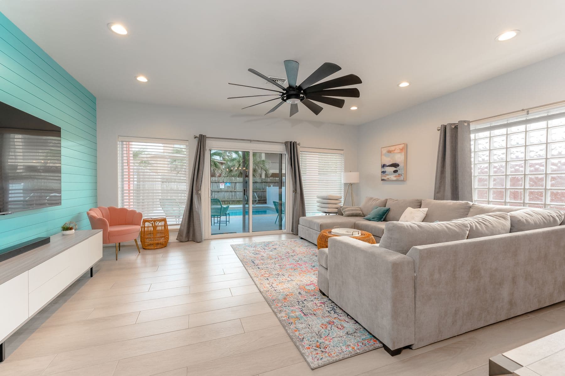 Living room with sectional and sliding doors to the pool