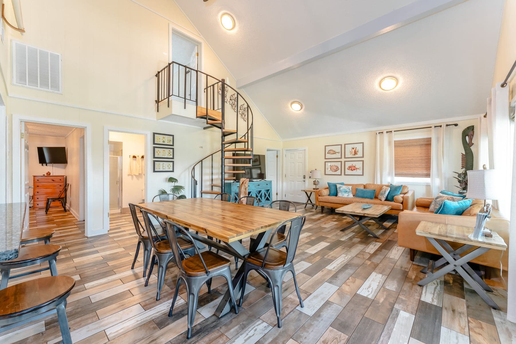Dining table and living area with spiral staircase