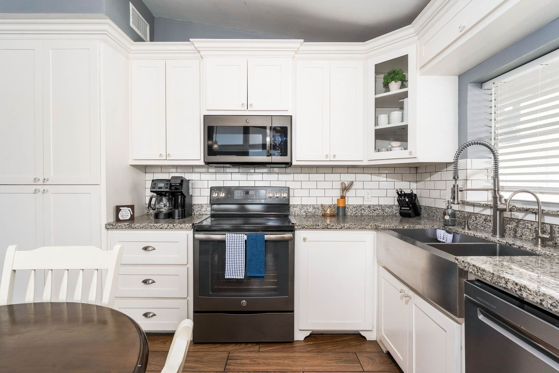 Upper-level kitchen with stainless appliances and tile backsplash